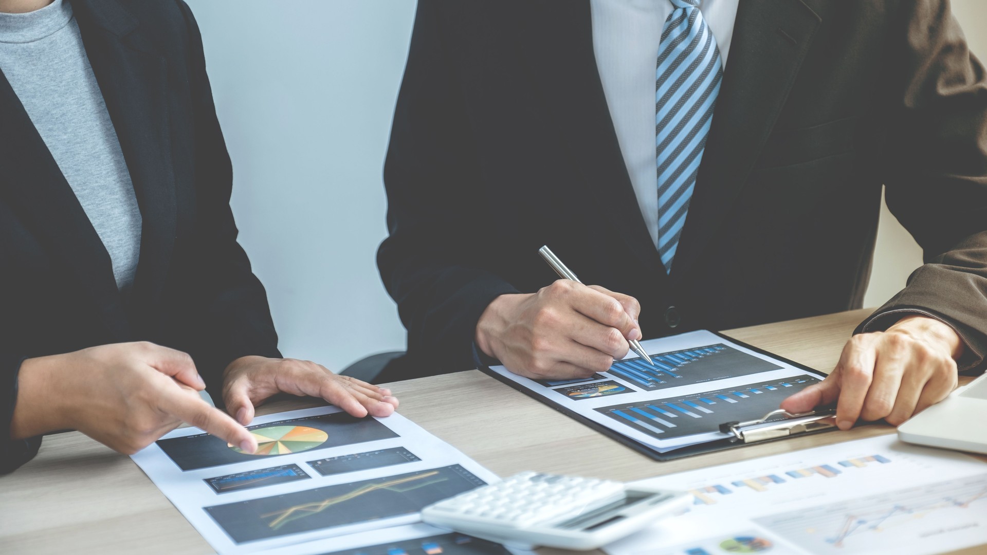 uomini d'affari e uomini d'affari si incontrano per pianificare strategie per aumentare il reddito delle imprese. Avere un'analisi del grafico brainstorming e discutere per il successo del nuovo target